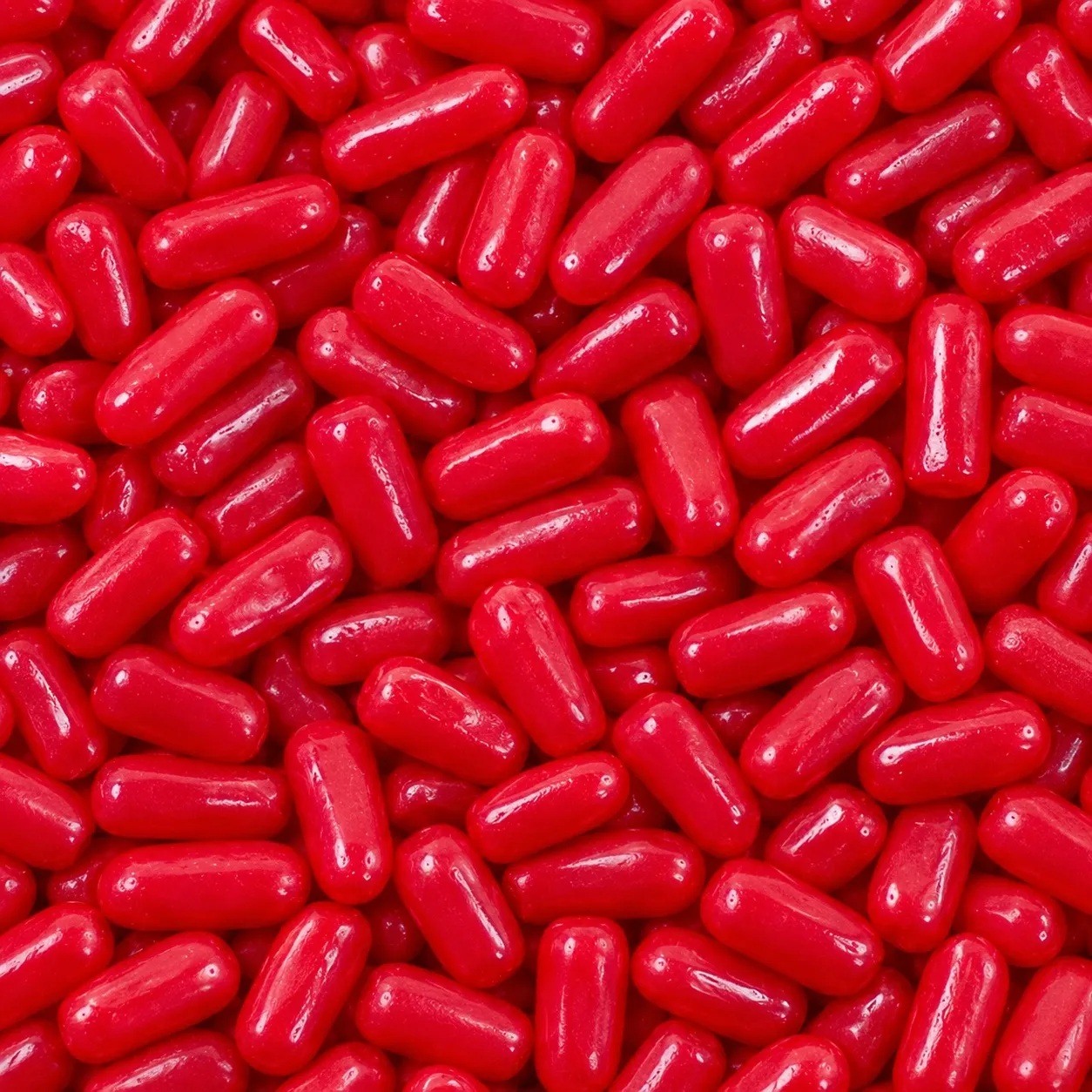 A pile of red Hot Tamales cinnamon candies